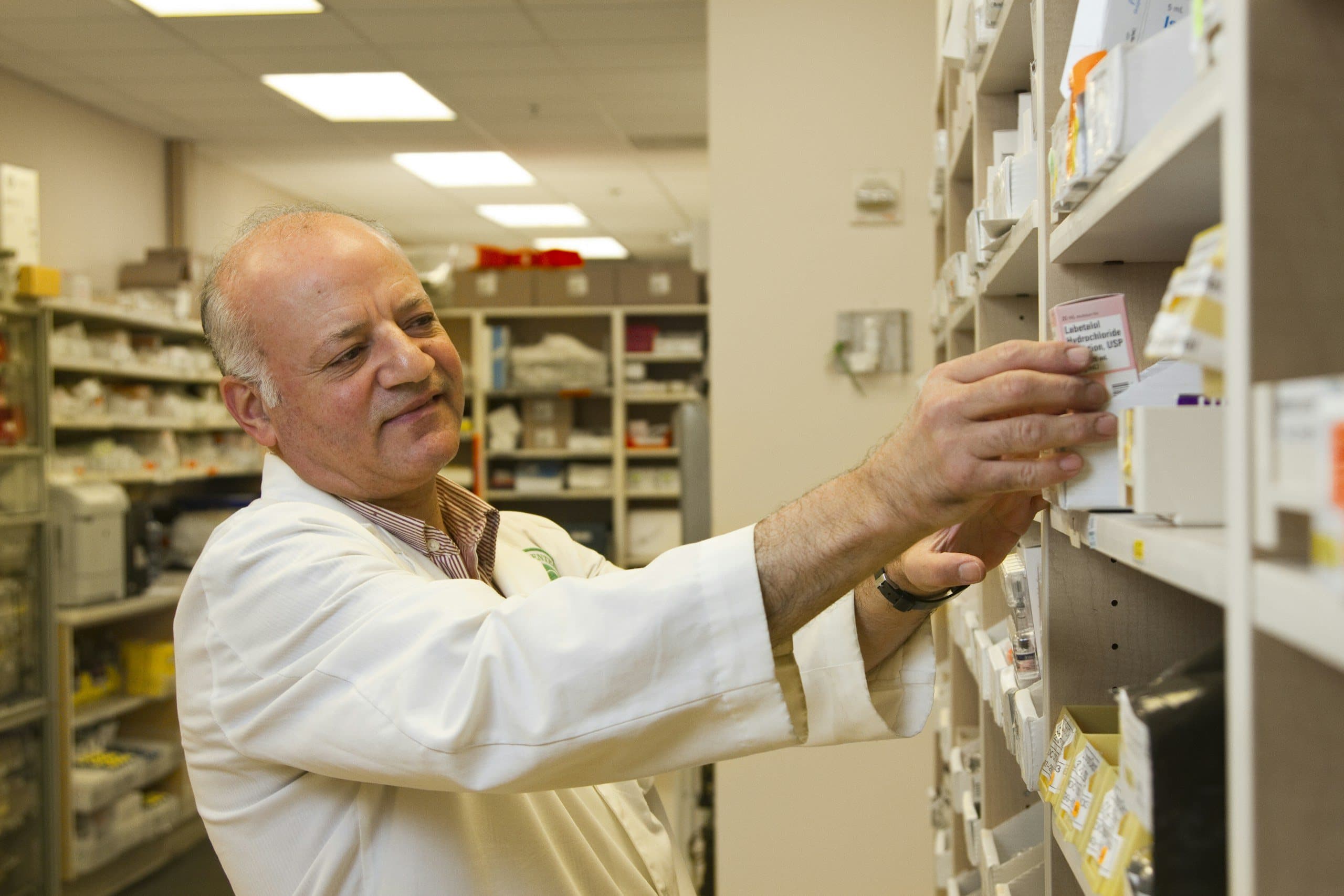 Pharmacist checking medications on the pharmacy shelves